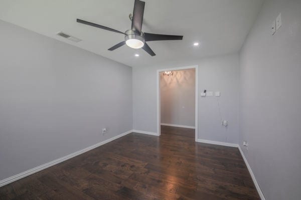 unfurnished room featuring ceiling fan and dark hardwood / wood-style flooring