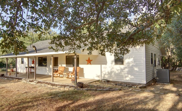 back of house featuring a patio area, cooling unit, and a lawn