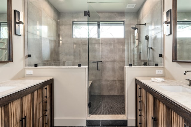 bathroom featuring vanity and a shower with shower door