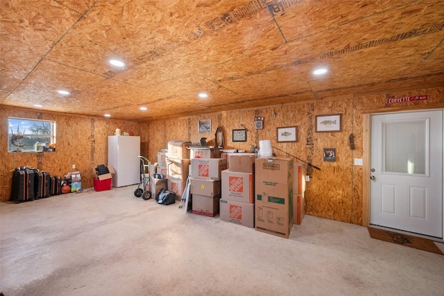 basement featuring white fridge