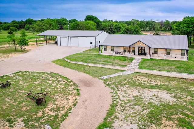 ranch-style house with an outbuilding, a porch, a garage, a front lawn, and a carport