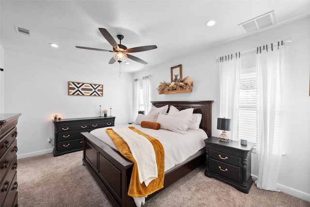 bedroom featuring light carpet and ceiling fan