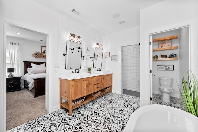 bathroom featuring toilet, a bath, and vanity