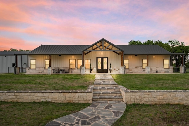 modern inspired farmhouse with a lawn and french doors