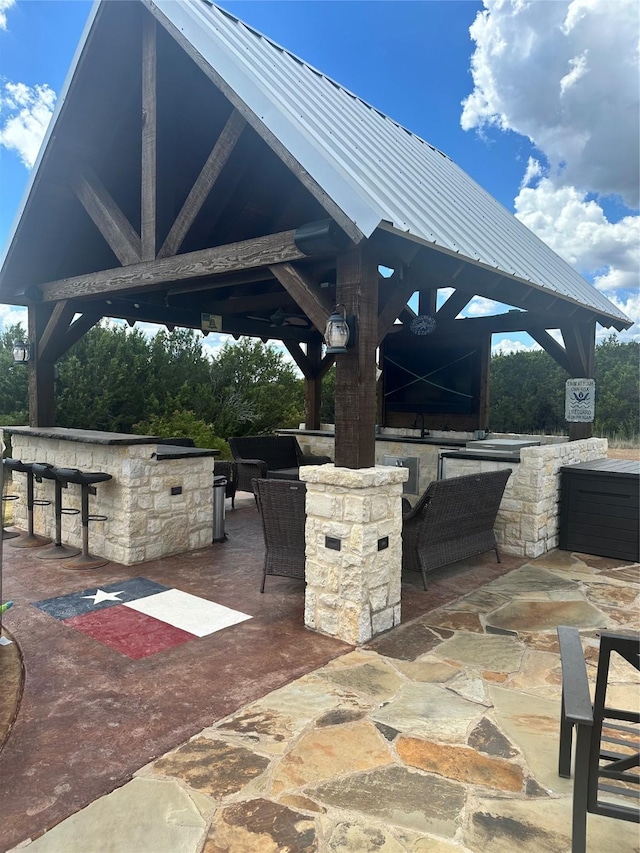 view of patio / terrace featuring a gazebo and a bar