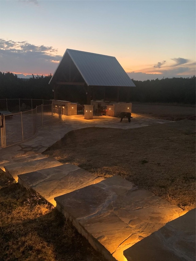 back house at dusk with exterior kitchen