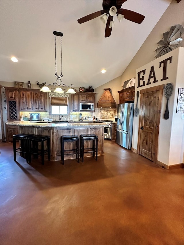 kitchen with a kitchen breakfast bar, backsplash, stainless steel appliances, a spacious island, and decorative light fixtures