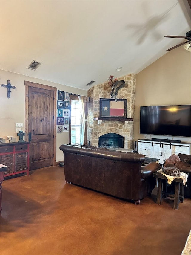 living room with a stone fireplace, ceiling fan, and vaulted ceiling