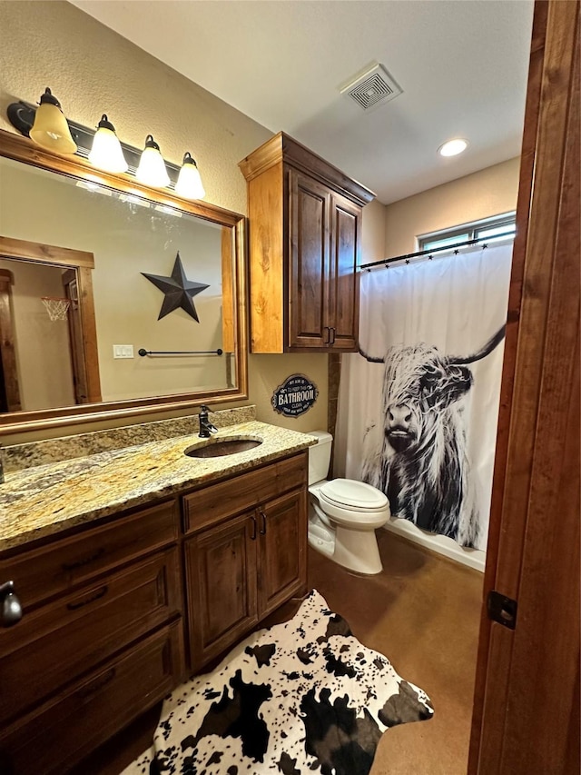 bathroom featuring vanity and toilet