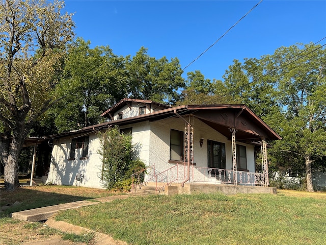 bungalow-style house with a front yard and a porch