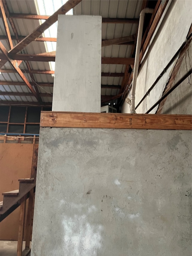 details featuring beam ceiling and concrete flooring