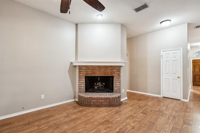 unfurnished living room with light hardwood / wood-style flooring, a fireplace, and ceiling fan