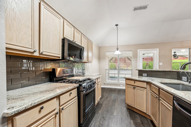 kitchen with light brown cabinetry, vaulted ceiling, dark wood-type flooring, sink, and stainless steel appliances