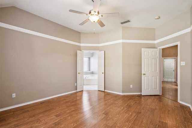 empty room with hardwood / wood-style flooring and ceiling fan