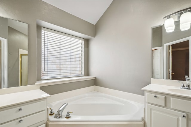 bathroom with vanity, vaulted ceiling, and independent shower and bath