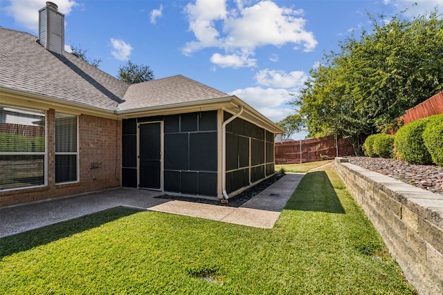 view of yard featuring a sunroom