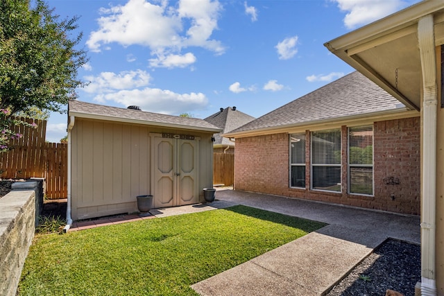 exterior space with a patio, a storage unit, and a lawn