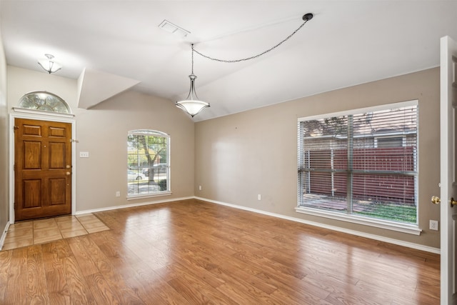 foyer entrance with lofted ceiling and light wood-type flooring