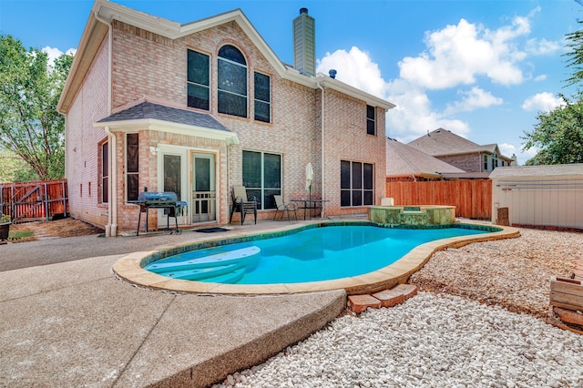 view of pool featuring grilling area, a storage unit, and a patio