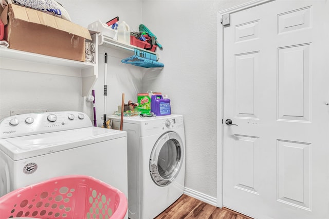 laundry area featuring washer and dryer and hardwood / wood-style floors