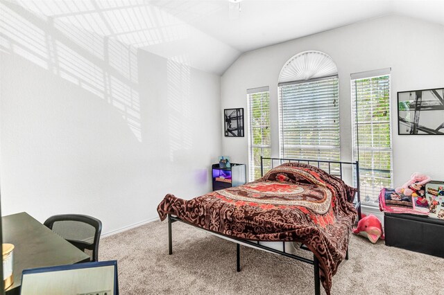 carpeted bedroom featuring vaulted ceiling