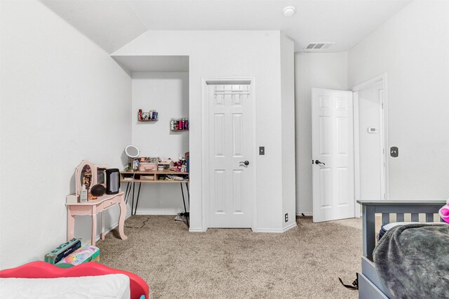 carpeted bedroom with vaulted ceiling