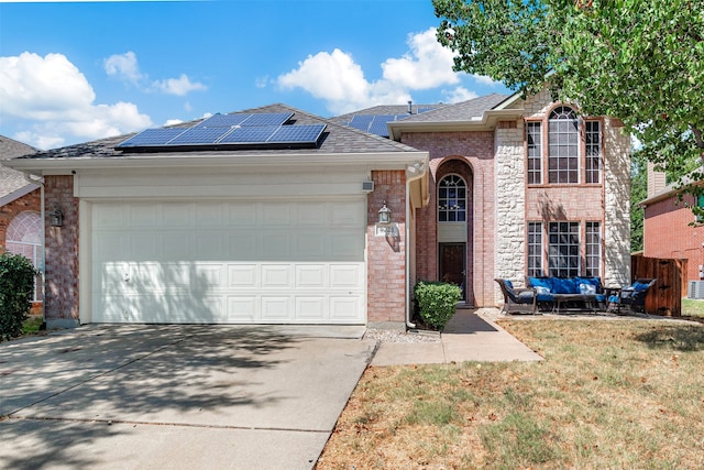 view of front of home featuring a garage and solar panels