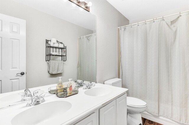 bathroom with vanity, toilet, a shower with shower curtain, and wood-type flooring