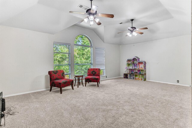 living area featuring lofted ceiling, ceiling fan, and carpet flooring