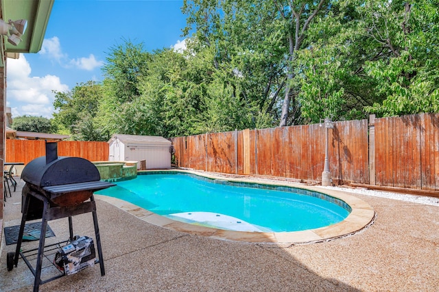 view of pool featuring a storage shed and a patio area