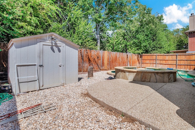 view of yard with a storage shed and a patio