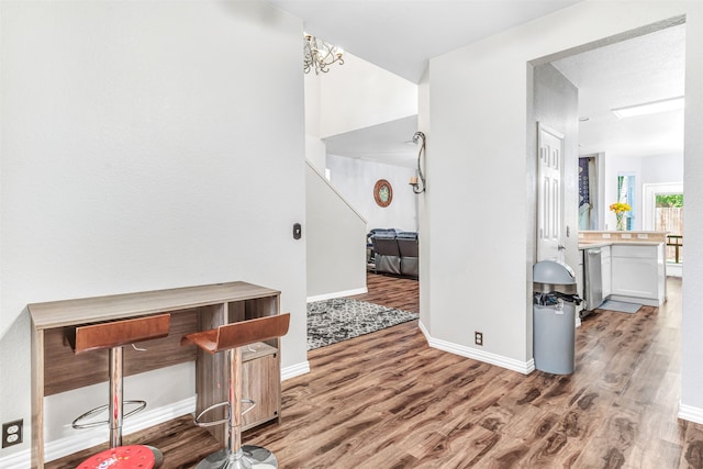 interior space with a textured ceiling and hardwood / wood-style floors