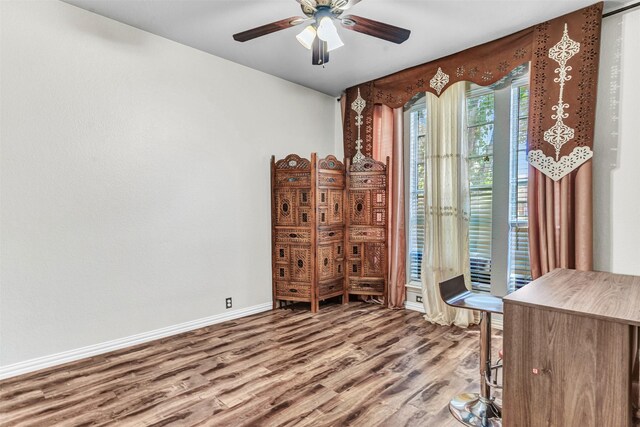 interior space with wood-type flooring and ceiling fan