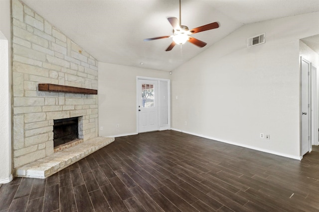 unfurnished living room featuring a textured ceiling, a fireplace, dark wood-type flooring, lofted ceiling, and ceiling fan