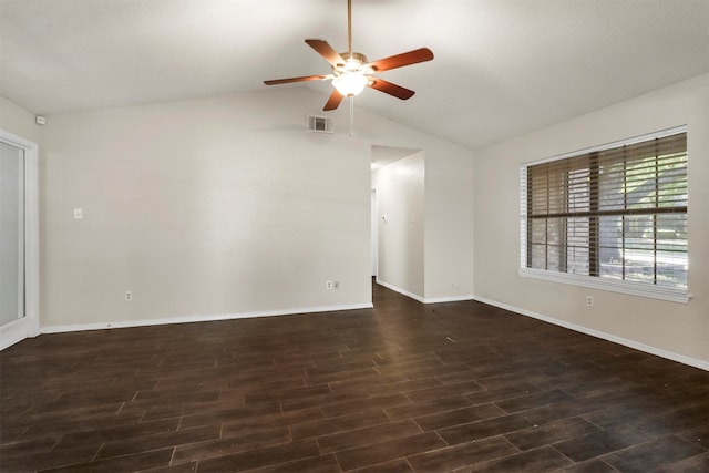 spare room featuring vaulted ceiling, dark wood-type flooring, and ceiling fan