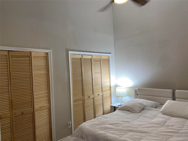 bedroom featuring multiple closets and ceiling fan