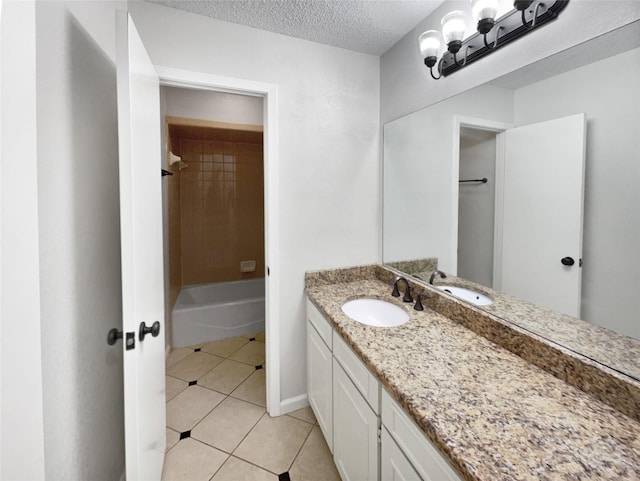 full bathroom with a textured ceiling, tile patterned flooring, a notable chandelier, vanity, and shower / washtub combination