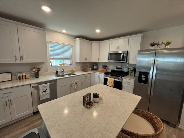 kitchen featuring a center island, a kitchen breakfast bar, hardwood / wood-style flooring, and stainless steel appliances