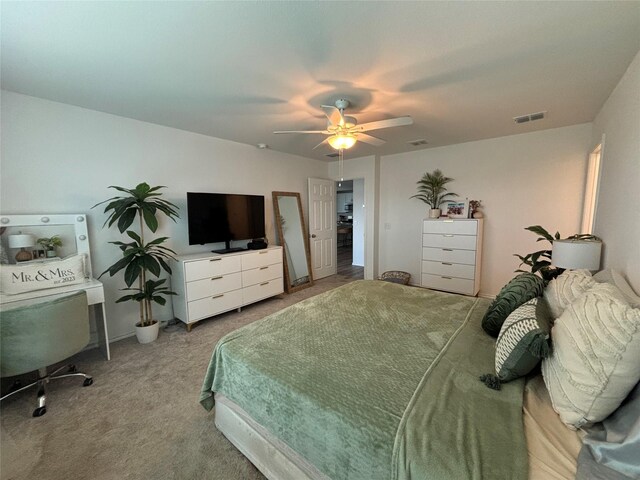 bedroom with ceiling fan and light carpet