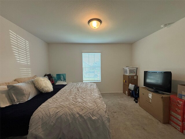 carpeted bedroom featuring a textured ceiling