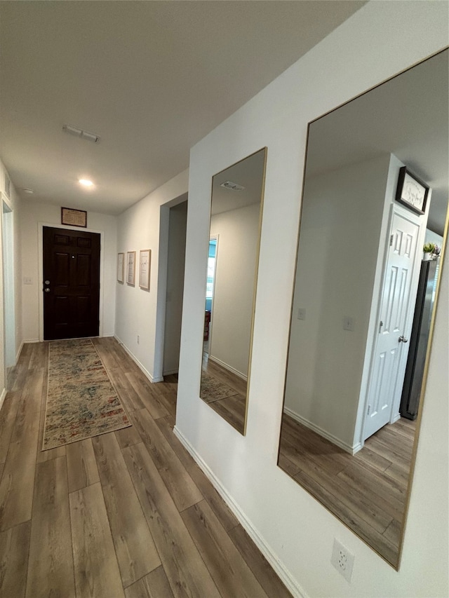 corridor featuring wood-type flooring