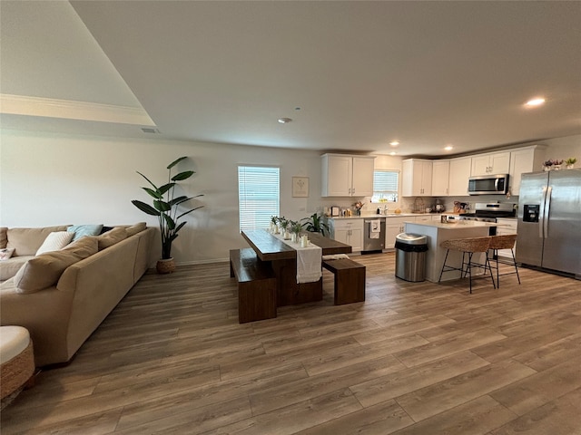 living room with dark hardwood / wood-style floors and sink