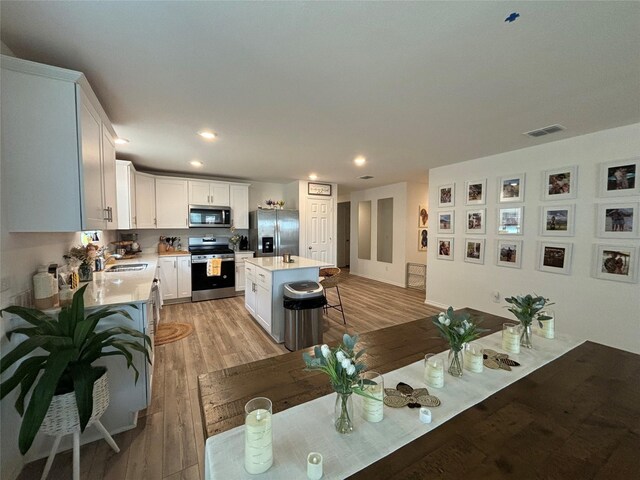 dining space featuring light hardwood / wood-style flooring and sink