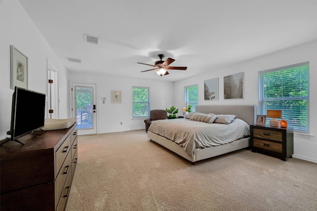 bedroom featuring access to outside, light carpet, ceiling fan, and visible vents