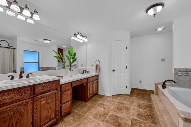 bathroom with tiled bath and vanity