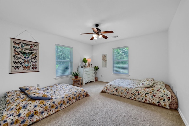 bedroom with light carpet and ceiling fan