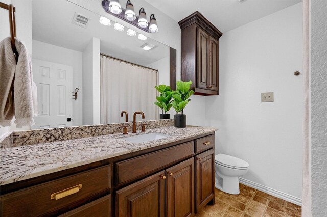 bathroom featuring toilet and vanity