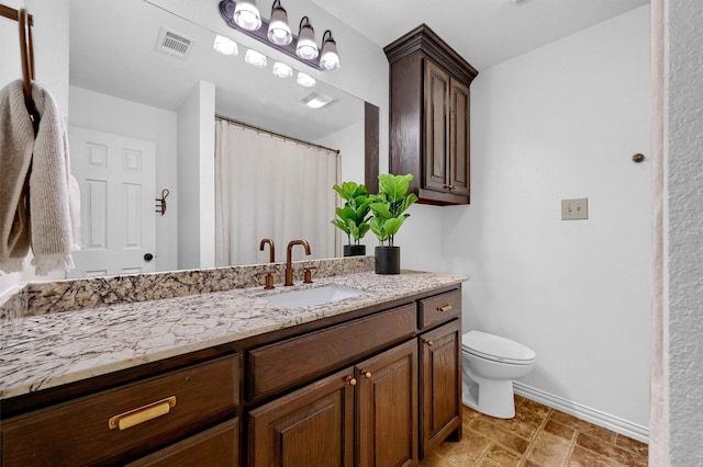 bathroom with toilet, baseboards, visible vents, and vanity