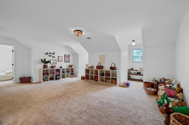 game room featuring carpet floors, visible vents, and vaulted ceiling