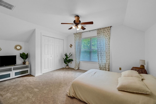 bedroom with visible vents, a ceiling fan, vaulted ceiling, carpet flooring, and a closet